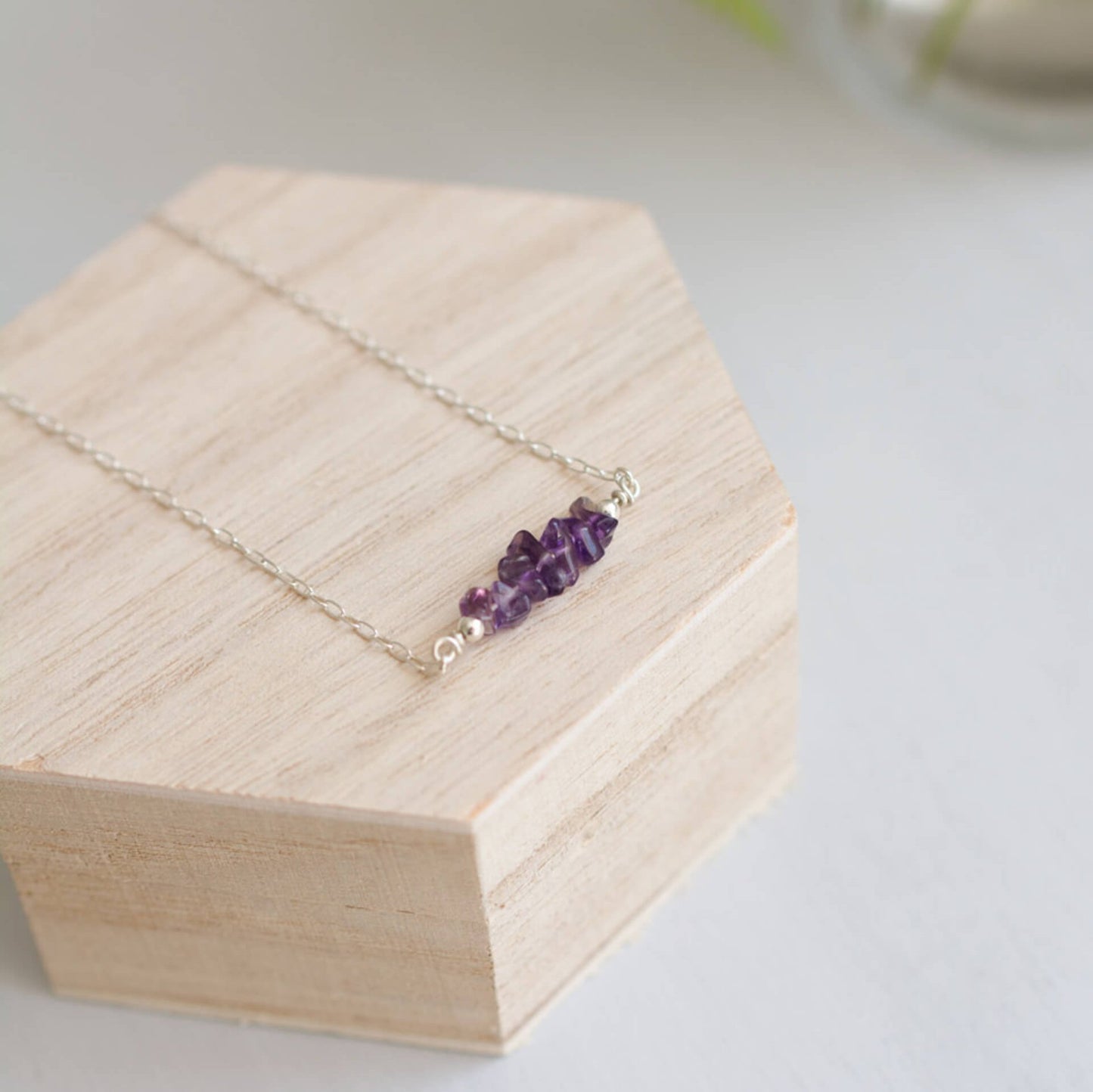 Purple handmade Amethyst Crystals Necklace on silver chain, sat on wooden box