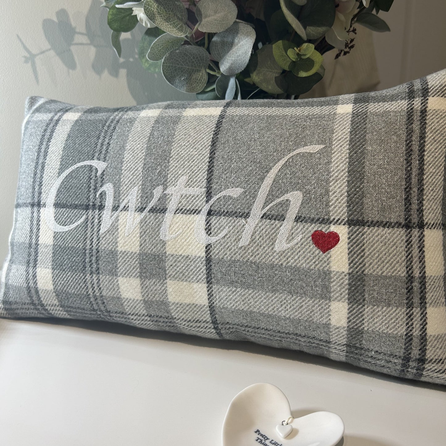 Stylish and understated, this grey Welsh Cwtch cushion is handmade in Wales from unique textiles. Perfect for adding a cosy touch to Welsh home décor.