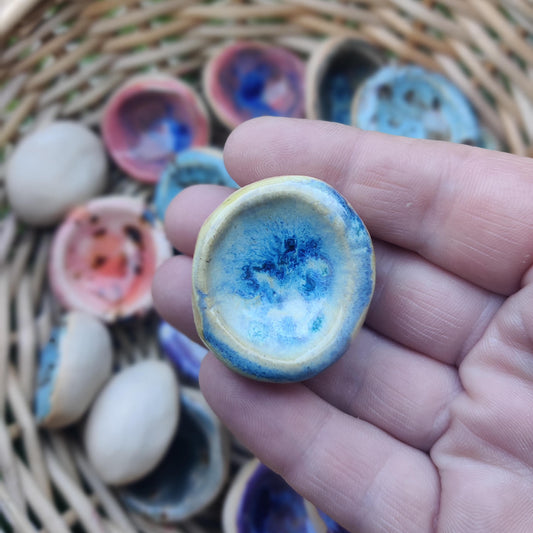 Handmade ceramic worry stone in a blue yellow glaze, designed to support mindfulness and ease stress.