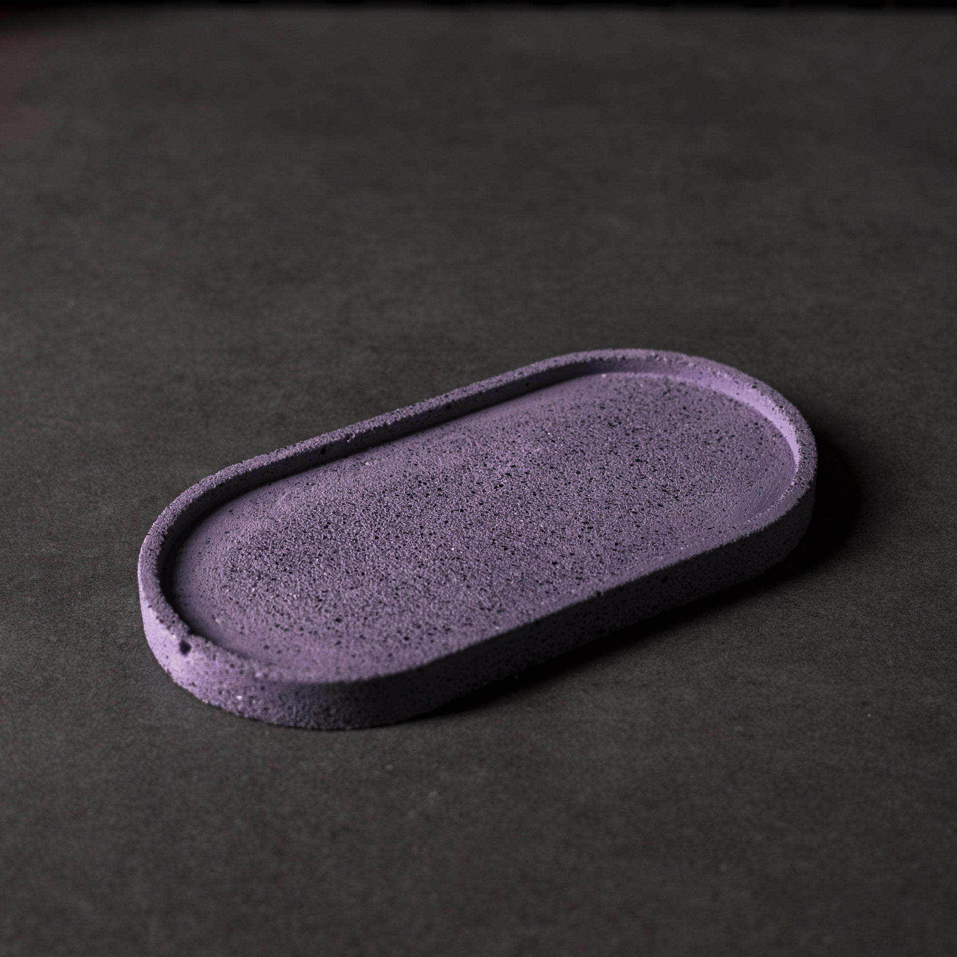Close up of purple concrete effect oval Jesmonite trinket tray, handcrafted in Wales, perfect for storing jewellery or small items as a gift