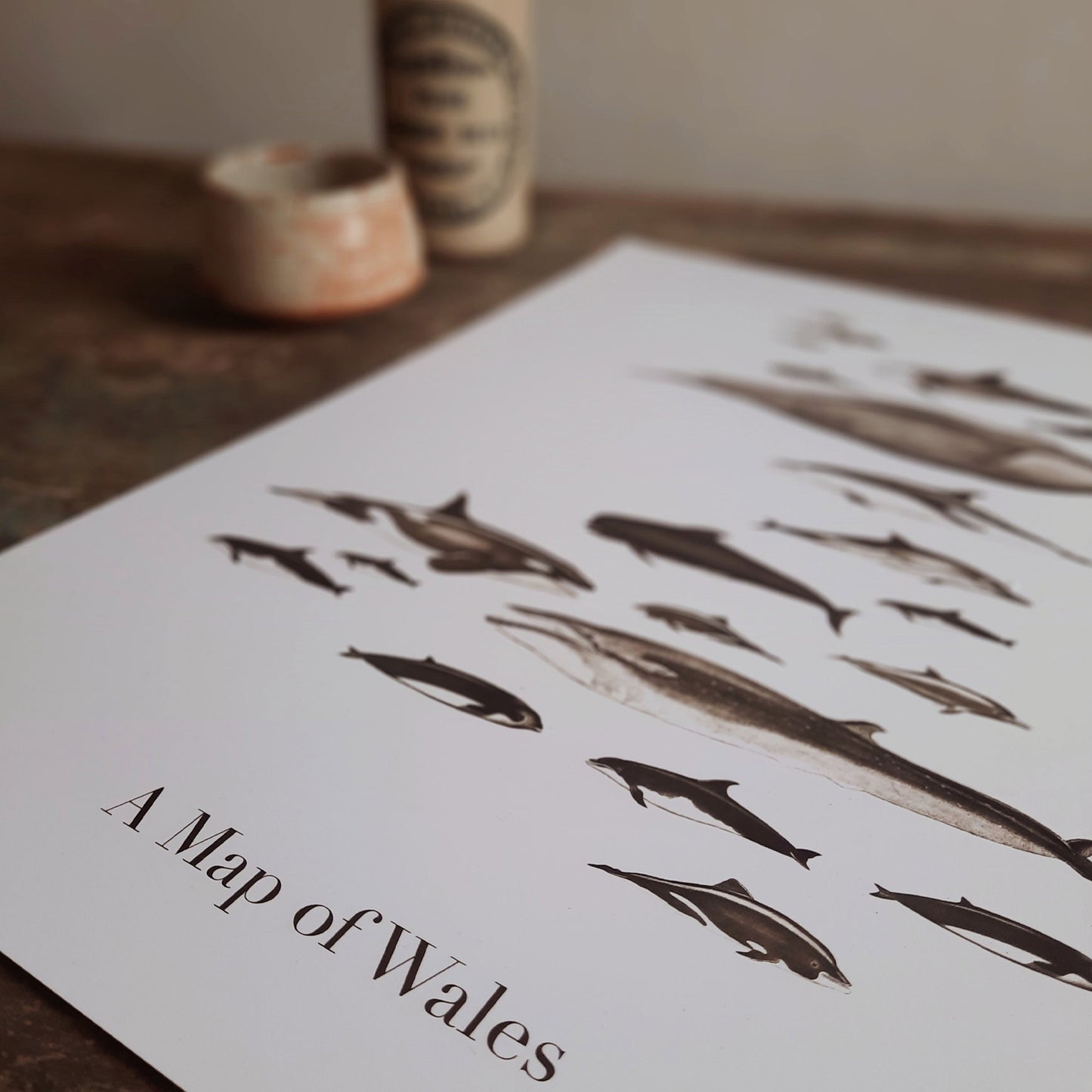 Art print featuring a composition of whales arranged in the shape of Wales, perfect for home decoration and gifting.