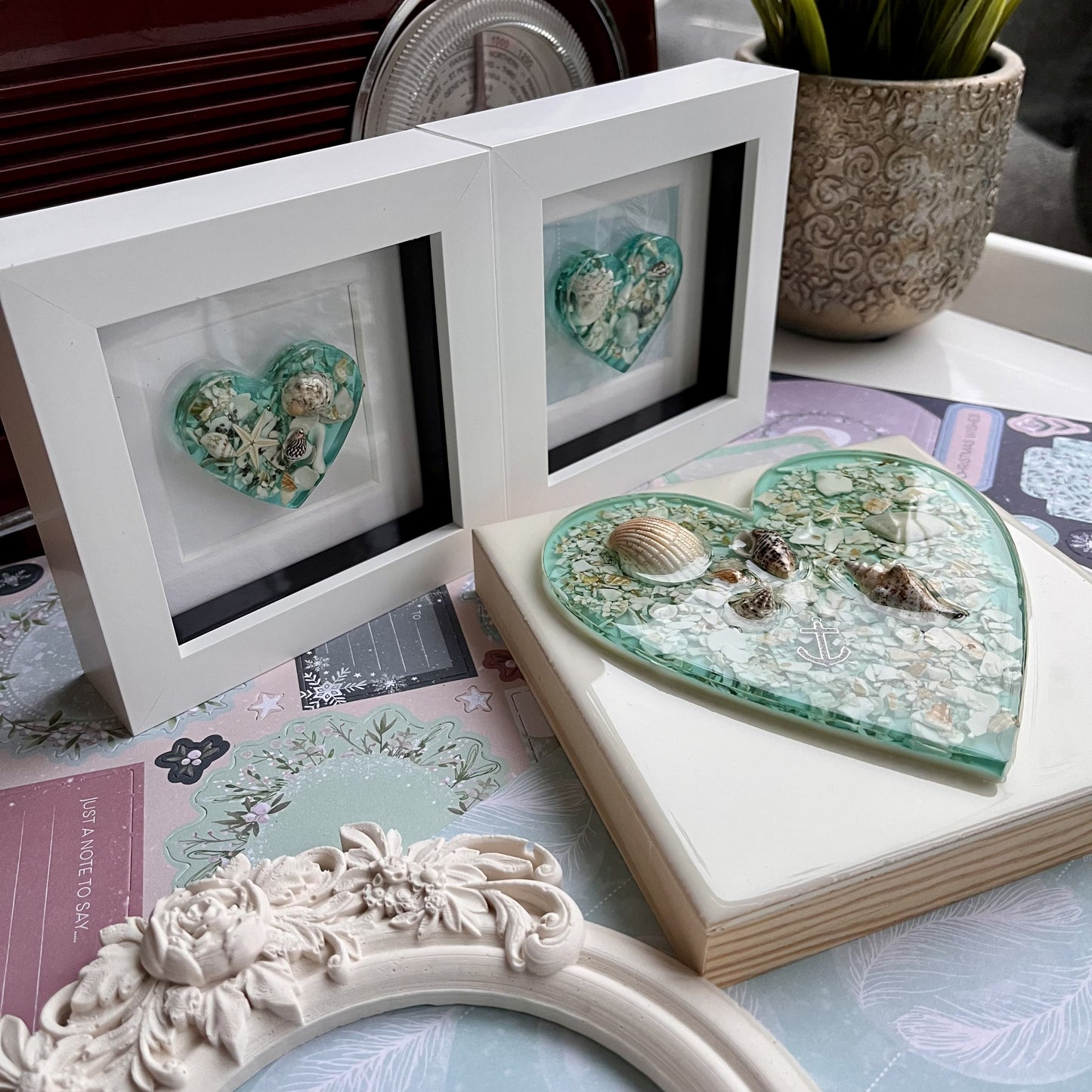 Handmade heart art in white frame with turquoise resin and shells