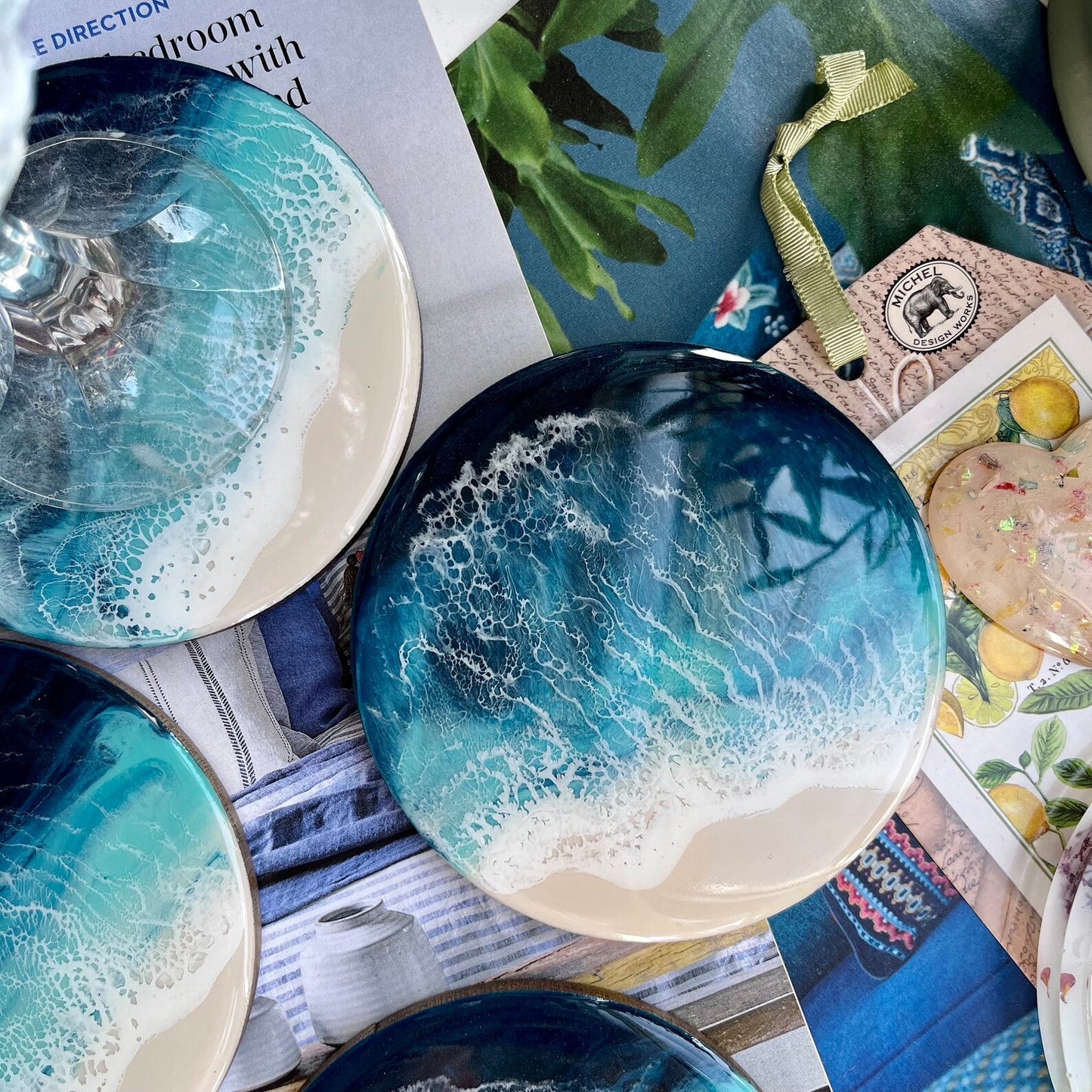 Decorative coasters with blue and white marbled design on a magazine background
