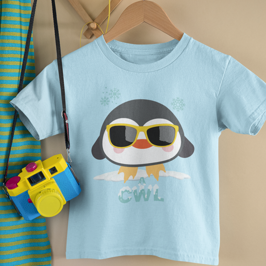 A kids' t-shirt featuring an illustrated penguin design, hung up on a wooden hanger. Perfect for new baby and toddler gifts, birthdays, school days, playtime or thoughtful Welsh gifts for children