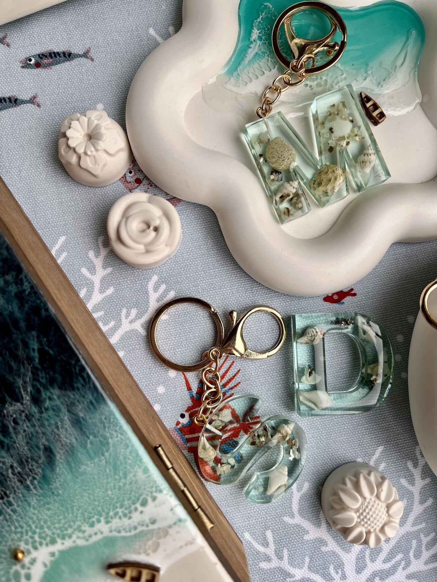 Decorative keychain with sea-themed charms on a textured surface