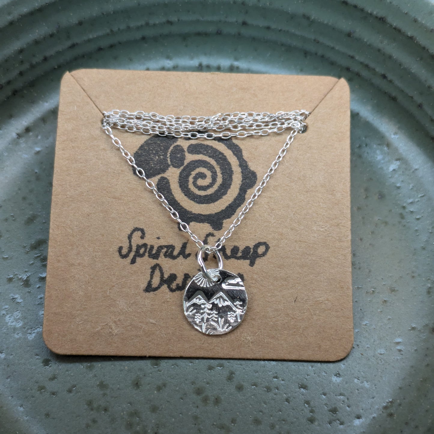 Recycled sterling silver disc pendant necklace featuring Welsh hill landscape design, perfect Christmas gift for her.