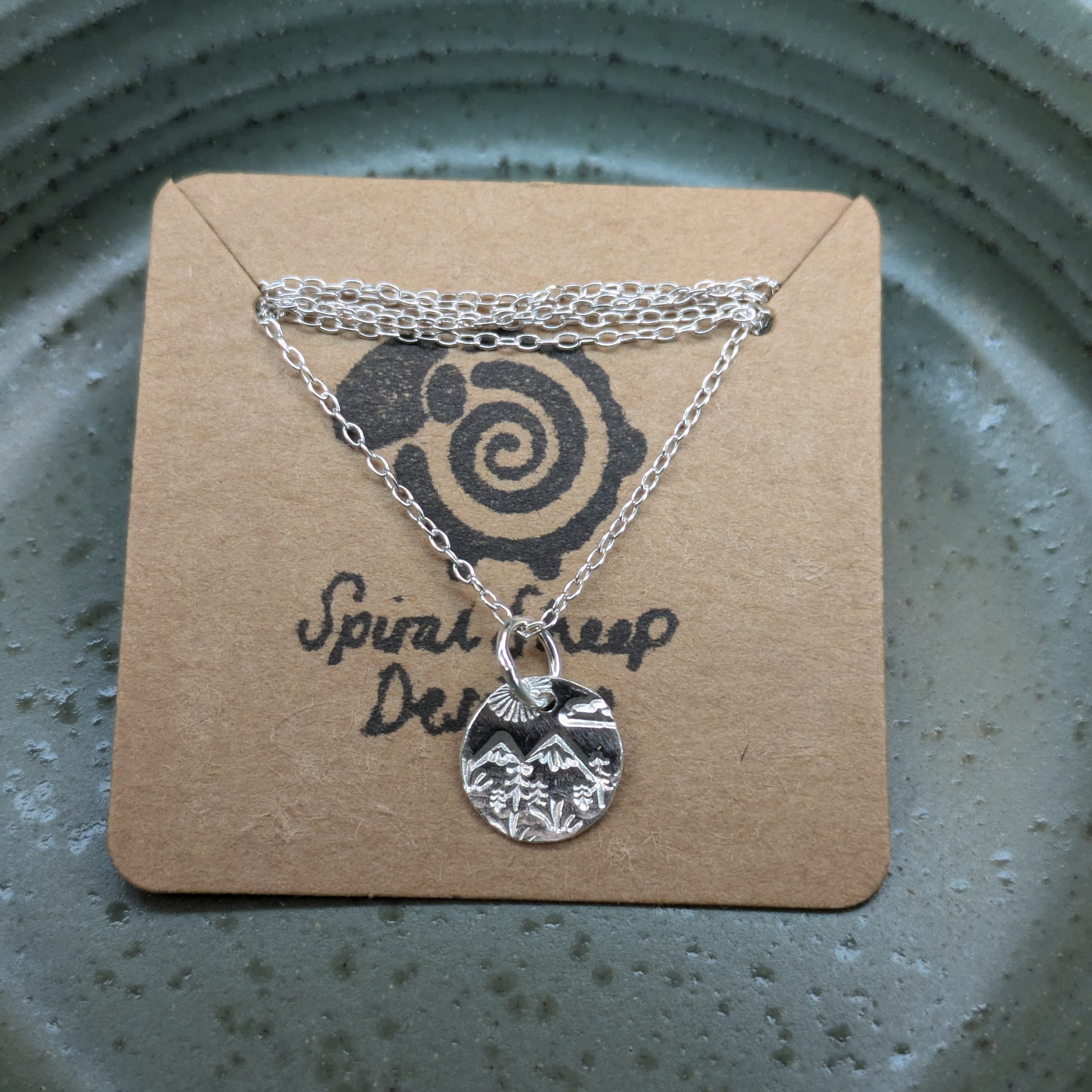 Recycled sterling silver disc pendant necklace featuring Welsh hill landscape design, perfect Christmas gift for her.