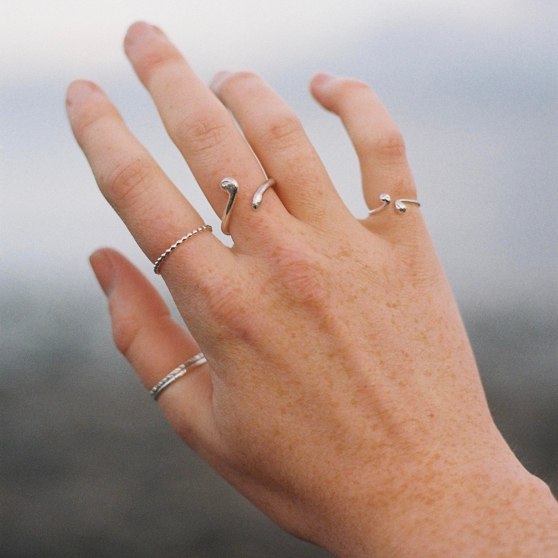 Silver adjustable ring as shown on hand