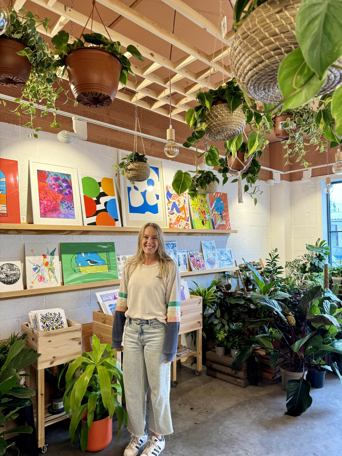 Photo of Gemma, founde of Byw in front of print exhibition