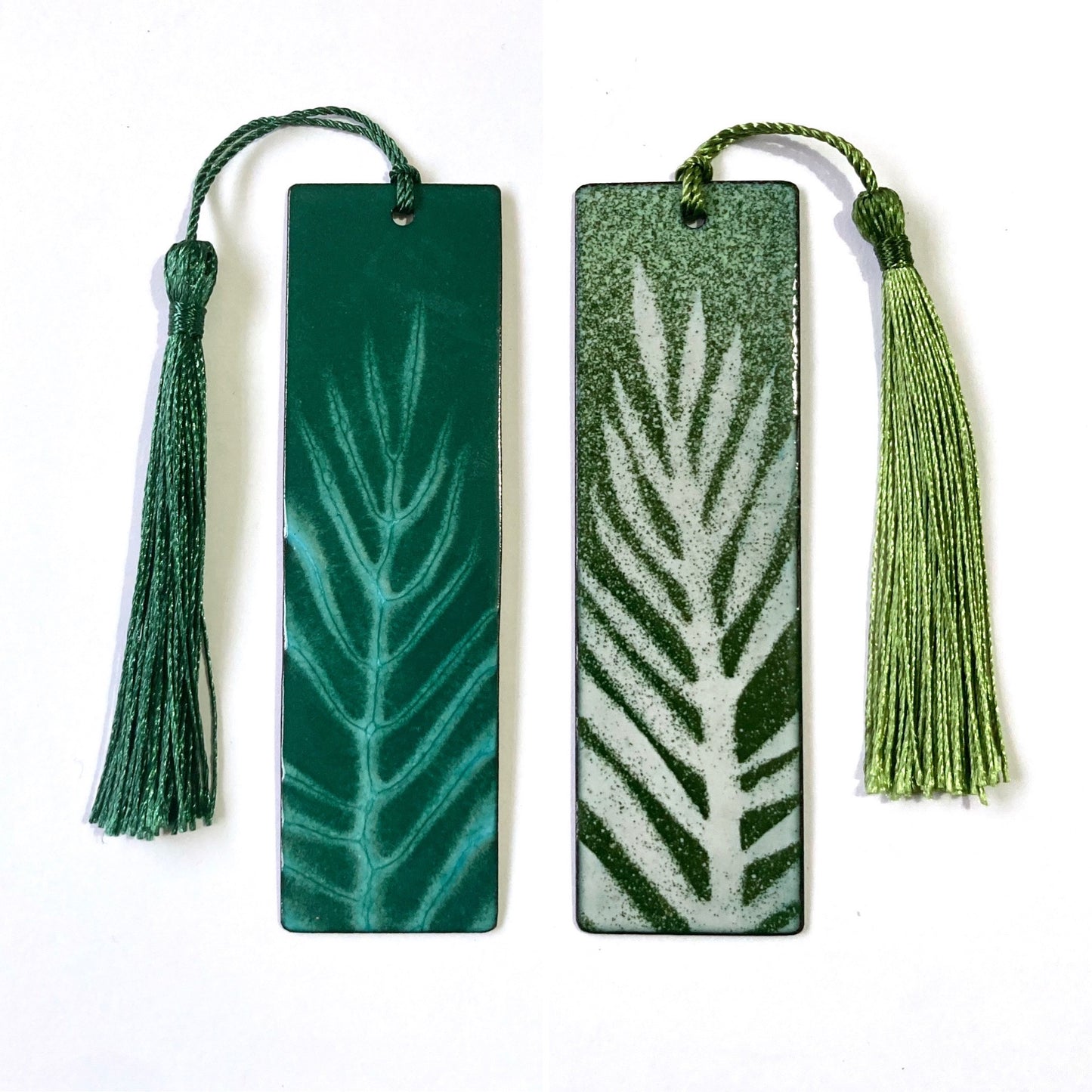 Two green bookmarks with tassels on a white background. Perfect for book lovers or secret santa christmas gifts.