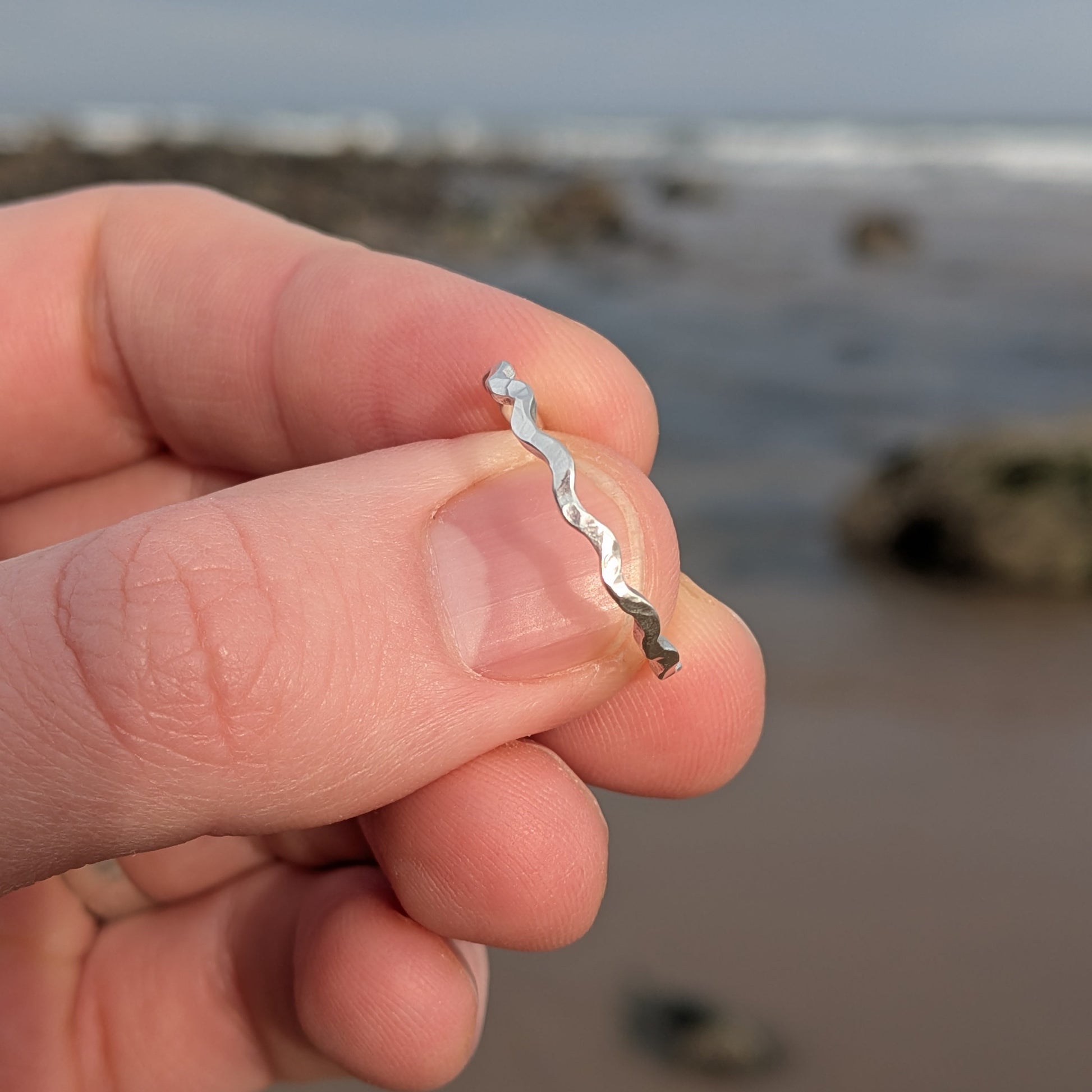 Close up of Tonnog sterling silver wavy ring crafted from recycled silver. perfect gift for her or for jewellery lovers