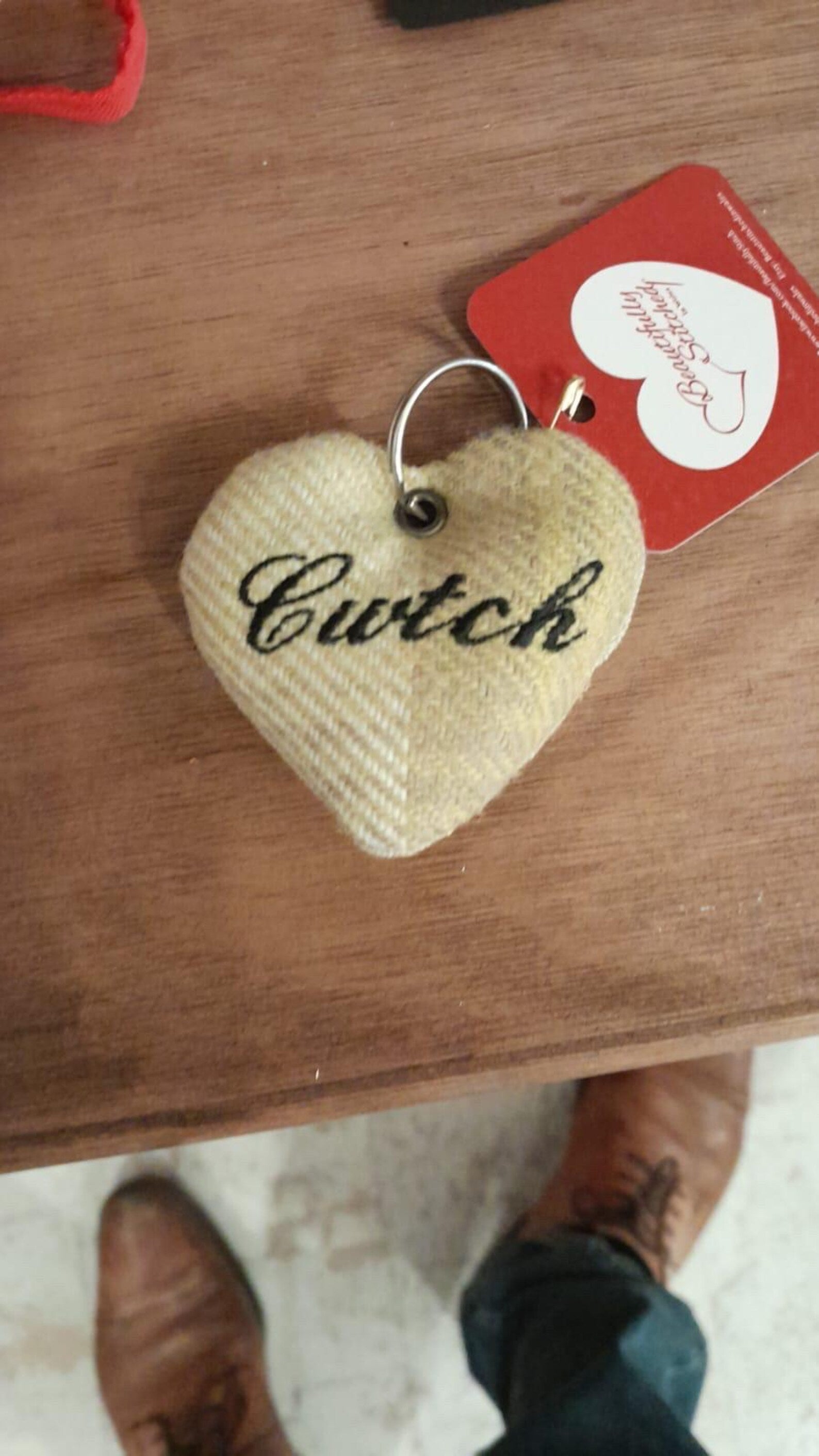 Handmade Heart-shaped keyring with 'Cwtch' text embroidered on surface. unique Welsh textile gift accessory for birthdays, Christmas, weddings