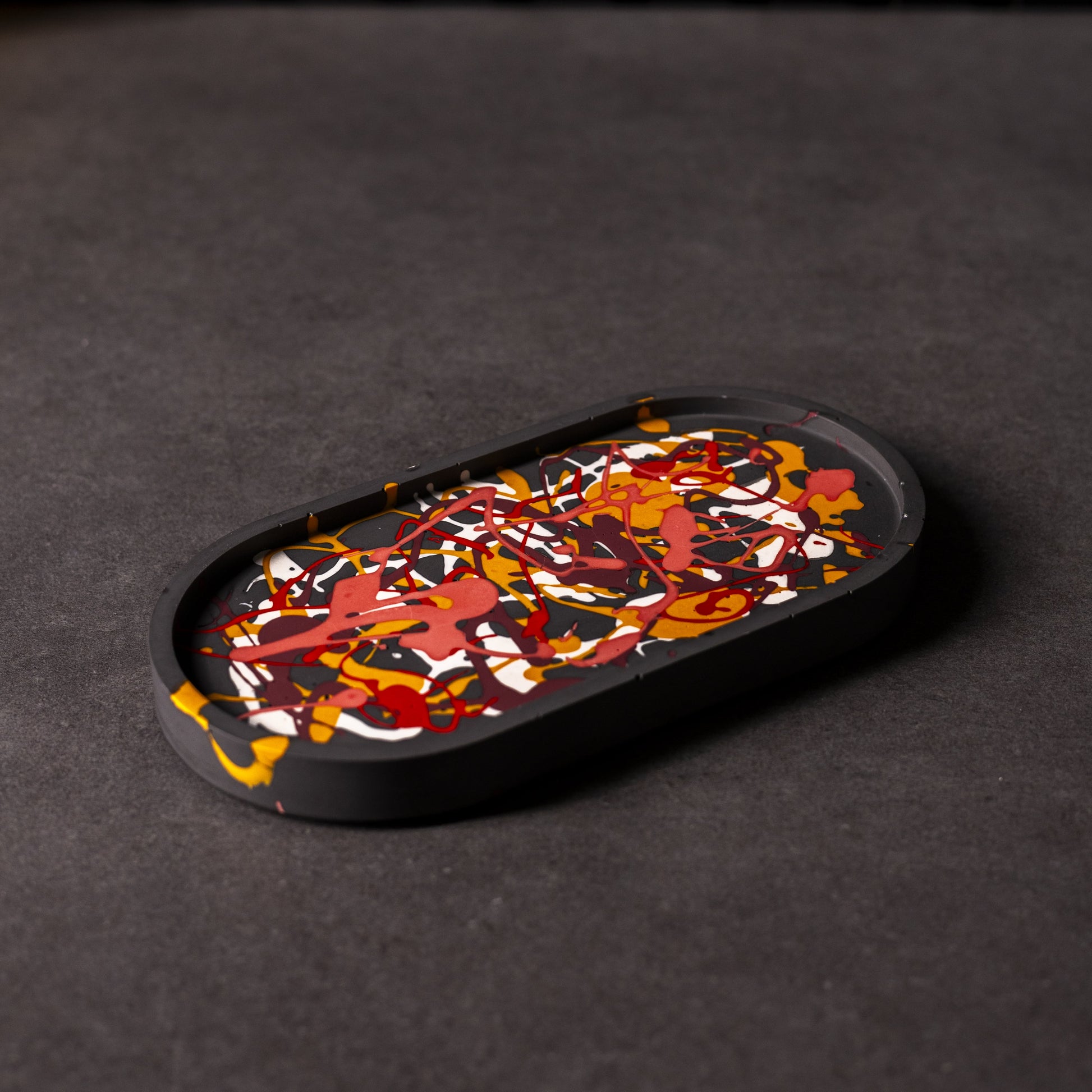 black and colourful splattered oval Jesmonite trinket trays in different colours, handcrafted in Wales, perfect for gifting or home décor