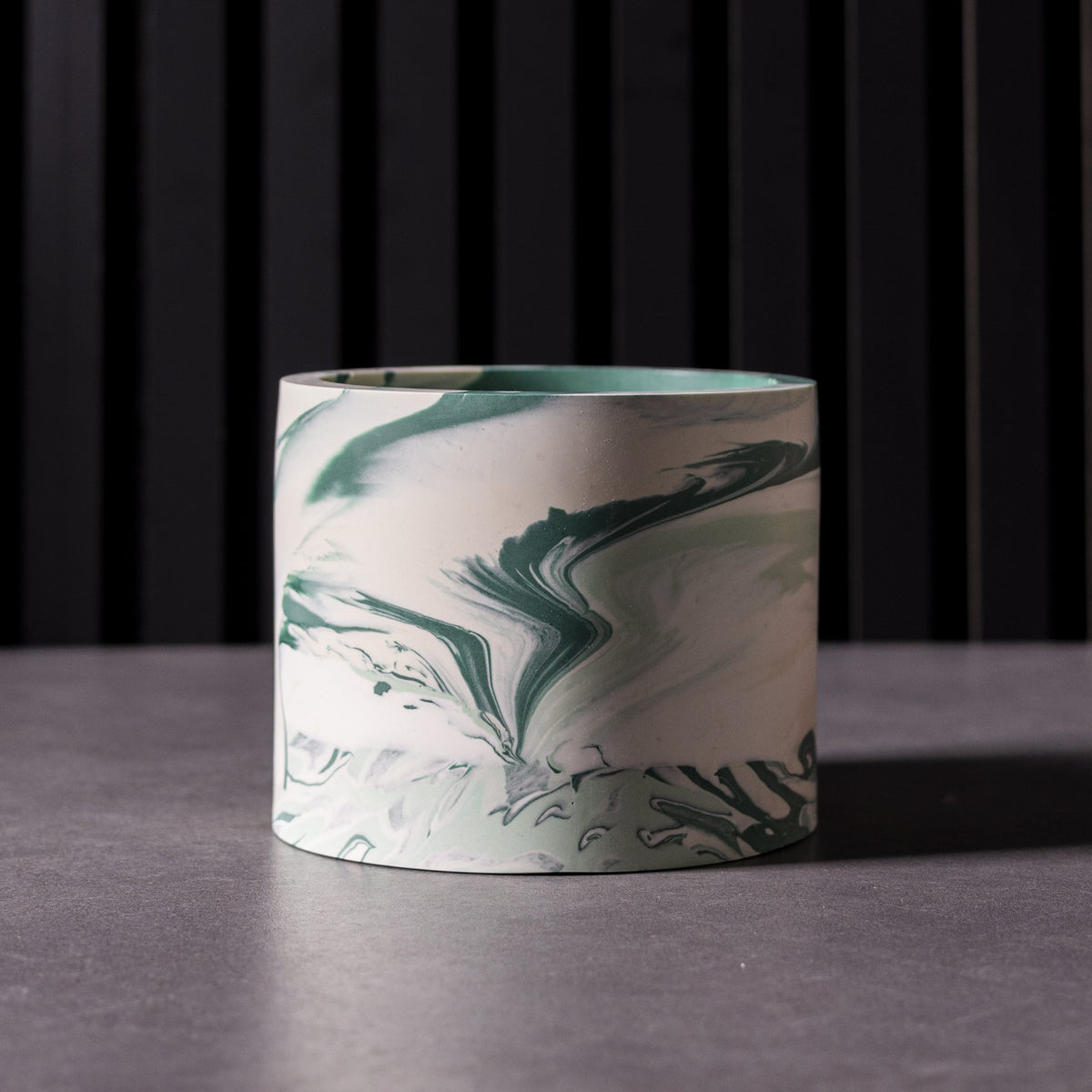 Close-up of unique teal/blue marbled handmade plant pot with one of a kind pattern, made in Wales, ideal for indoor plants or stylish storage