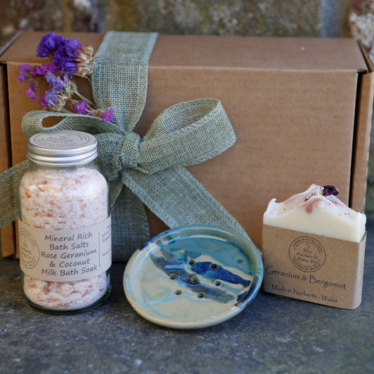 Close up of unique handmade gift box featuring ceramic soap dish, artisan soap bar and bath salts in kraft gift box, made in Wales, perfect for Christmas gifts.