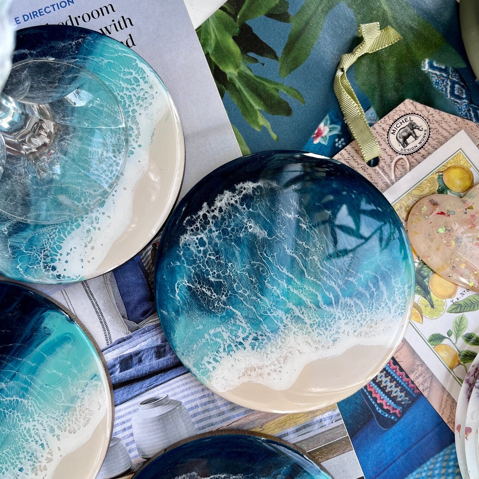 Decorative coasters with blue and white marbled design on a magazine background