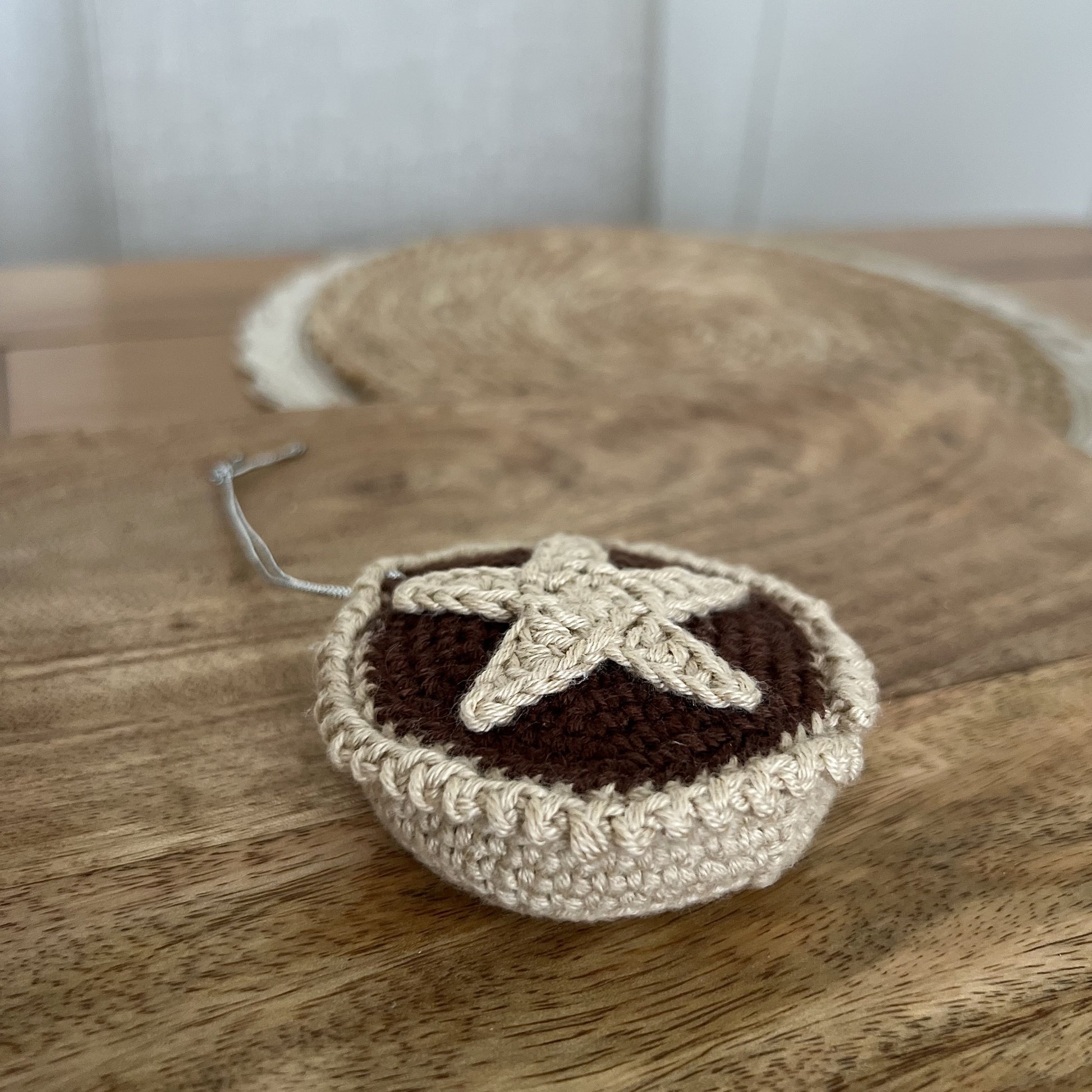 Crocheted Christmas mince pie ornament in warm, festive colours, handmade in Wales