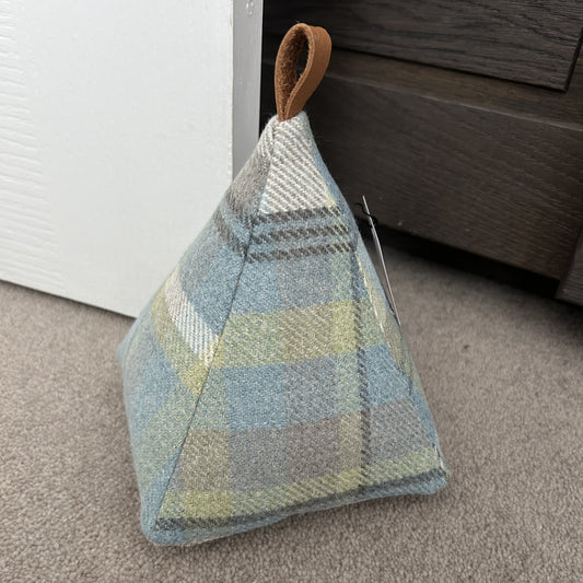Duck egg blue handmade Welsh wool pyramid doorstop with looped leather handle, soft-touch fabric, unique Welsh home accessory.