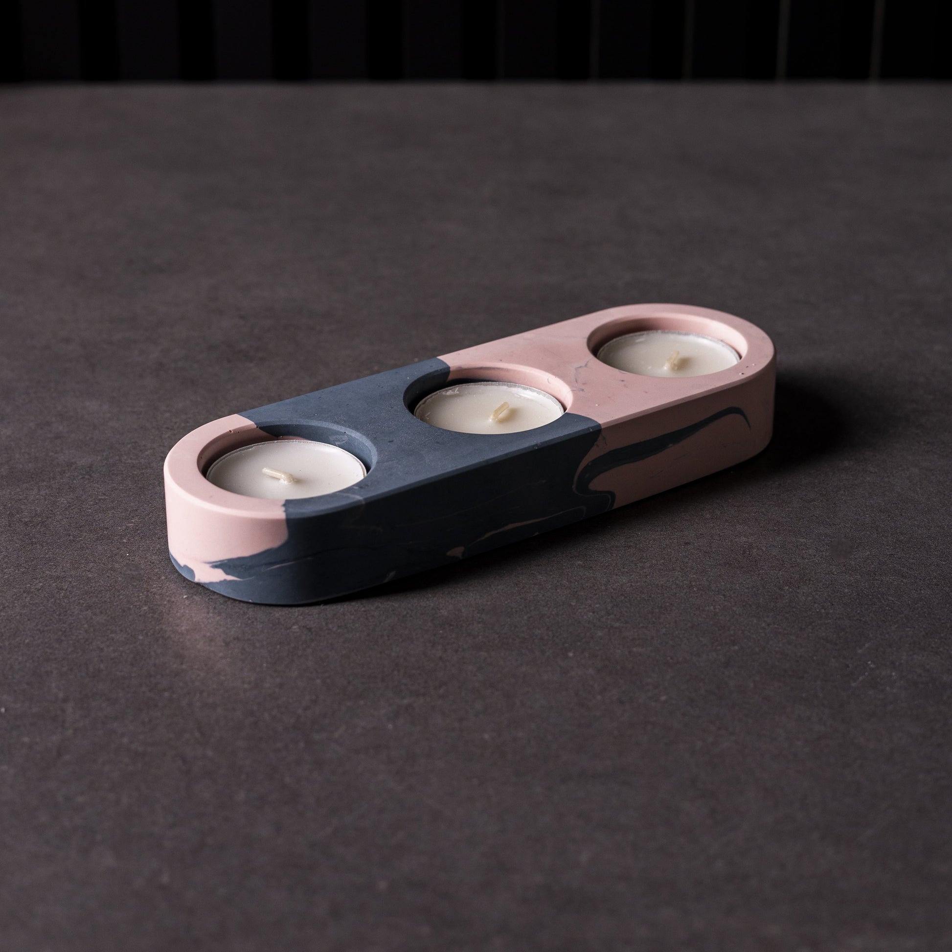 Jesmonite triple candle holder on Black granite background, made in Wales