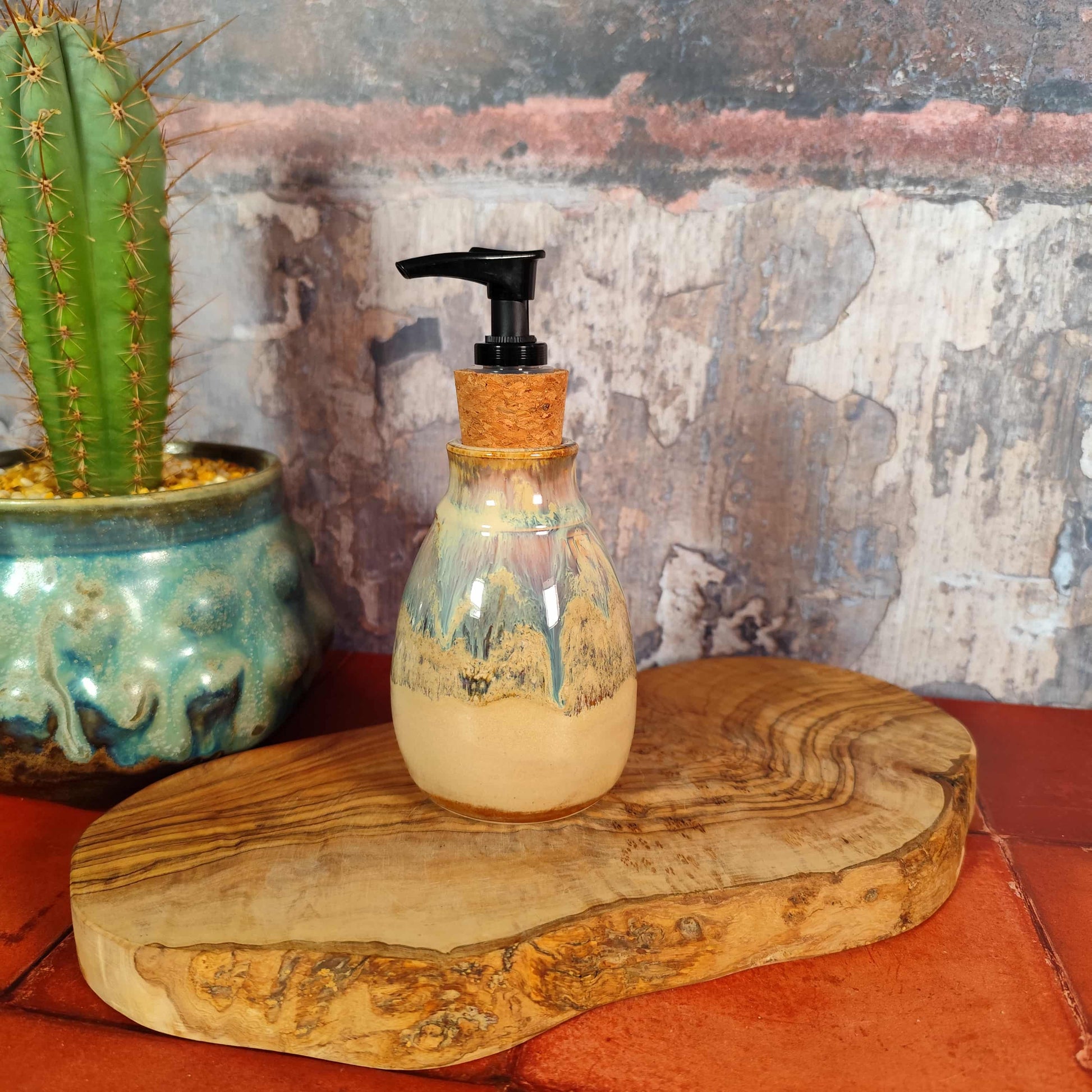 Handmade ceramic soap pump with oat and blue speckled glaze.