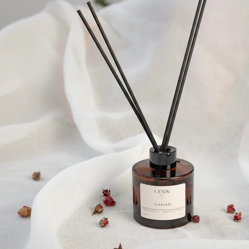 Diffuser with reeds on a white fabric background. Minimal home scent diffuser gift for her.