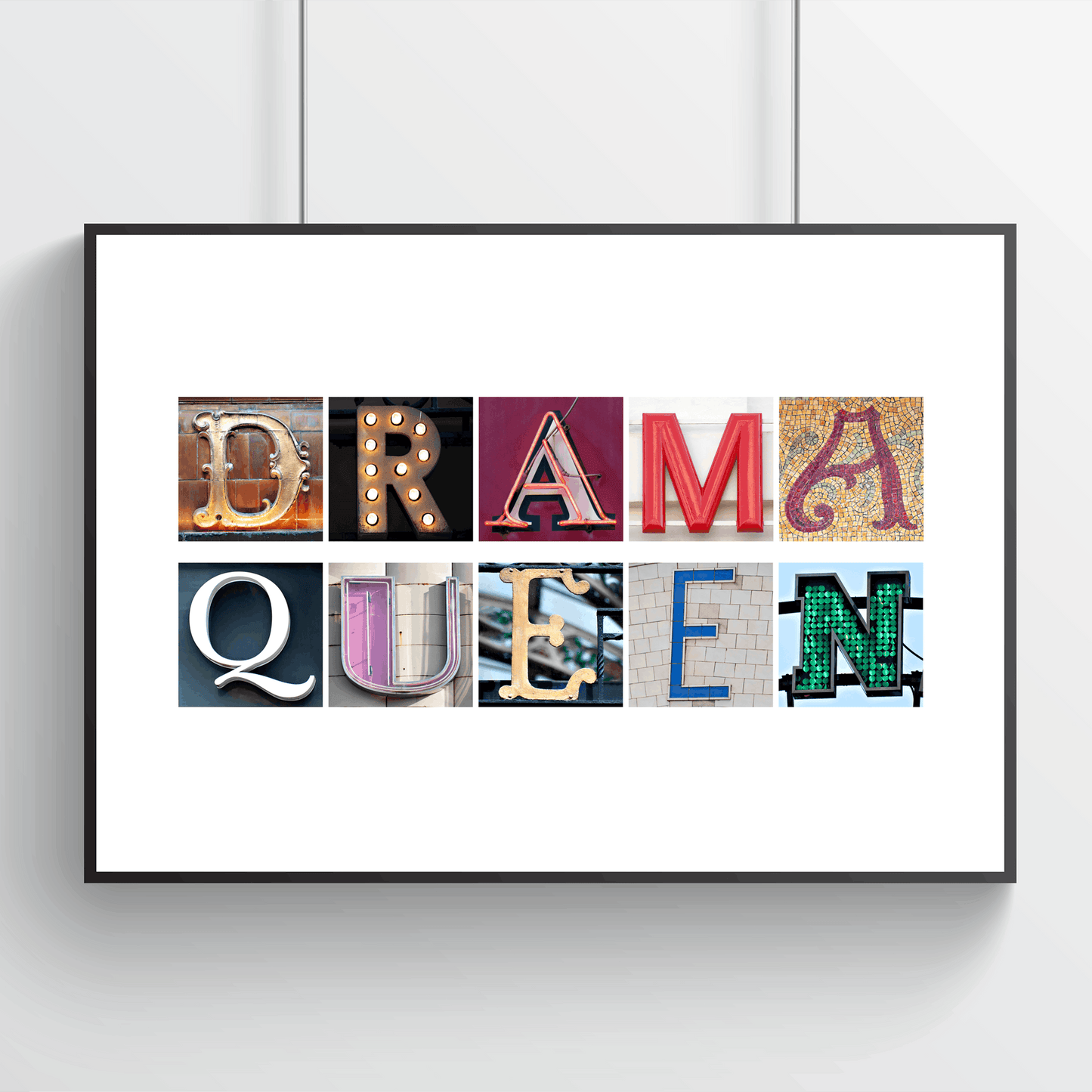 Framed artwork with colourful letters spelling 'Drama Queen' on a white background. Quirky Drama Queen wall art from independent artist in Wales.