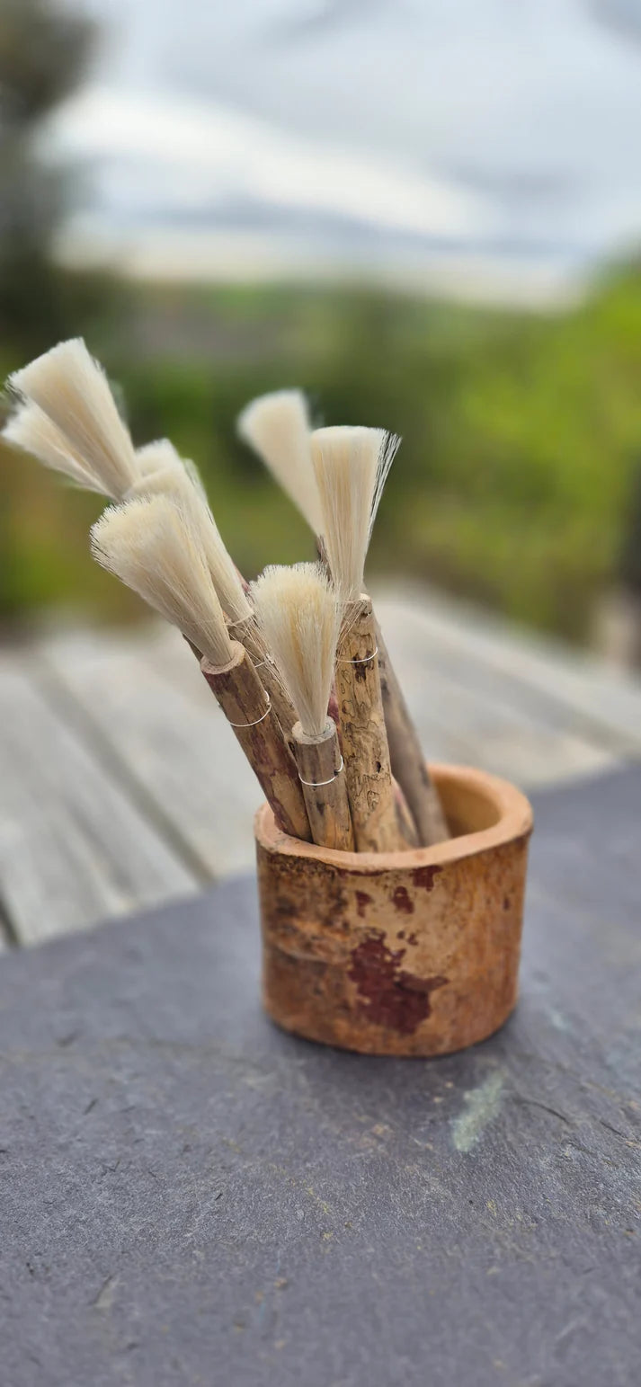 Handmade natural fibre paintbrush with driftwood handle