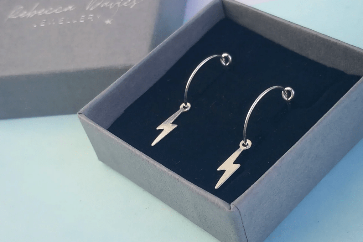 Sterling silver lightning bolt hoop earrings, handmade in Wales, minimalist statement jewellery gift