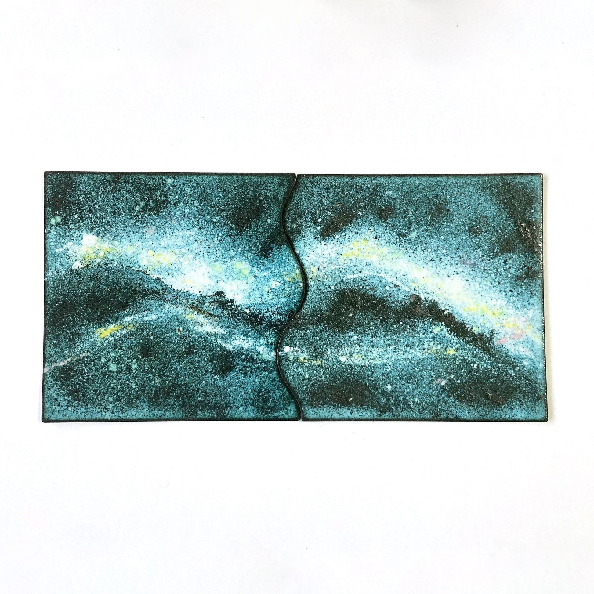 Set of two hand-enamelled copper coasters that join together to create a Milky Way design.