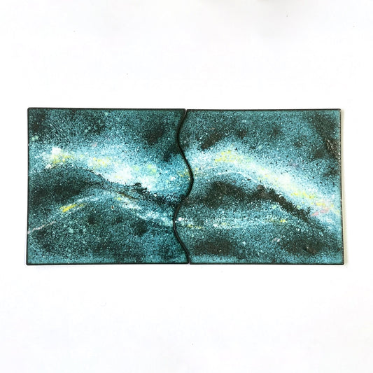 Set of two hand-enamelled copper coasters that join together to create a Milky Way design.