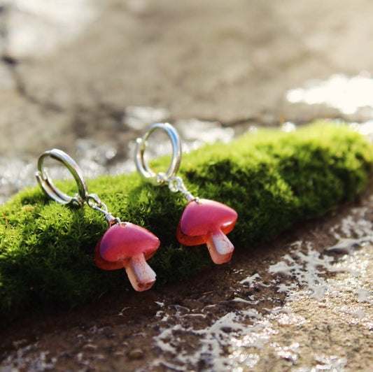 Dainty mushroom earrings made from bio resin with silver huggie hoops, handmade in Wales.