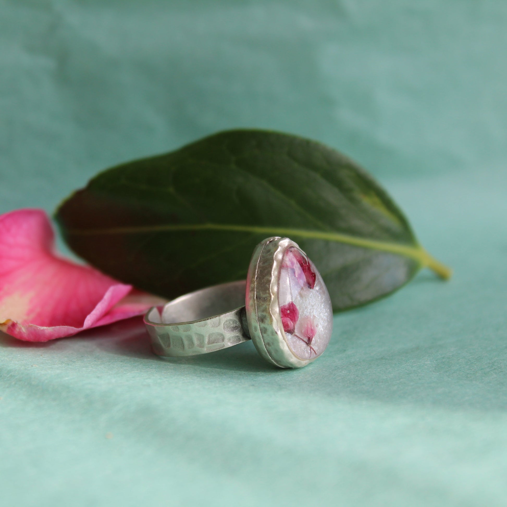 Hammered silver-plated adjustable ring with Japanese blossom resin design. Made in Wales.