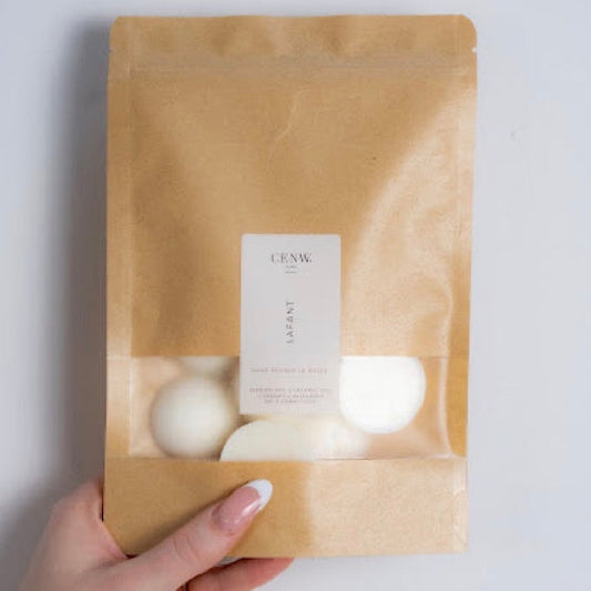 Handmade scented wax melts in kraft paper bag, supporting small Welsh business. 