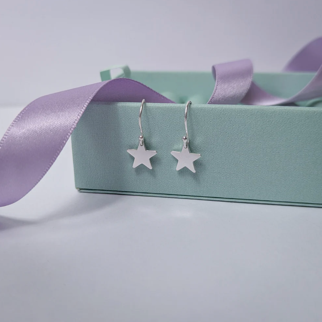 Handmade sterling silver little dangly star earrings, each star approx 10mm across, perfect for gifting or everyday wear.