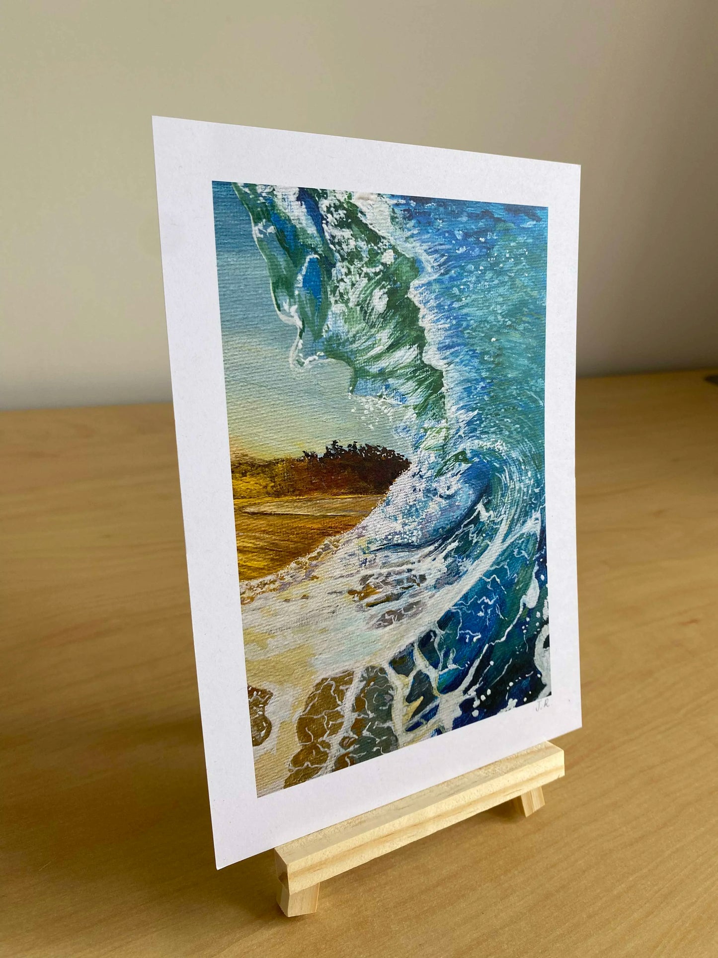 Art print of a wave crashing onto a beach. Sea inspired artwork supporting independent artist from Wales.