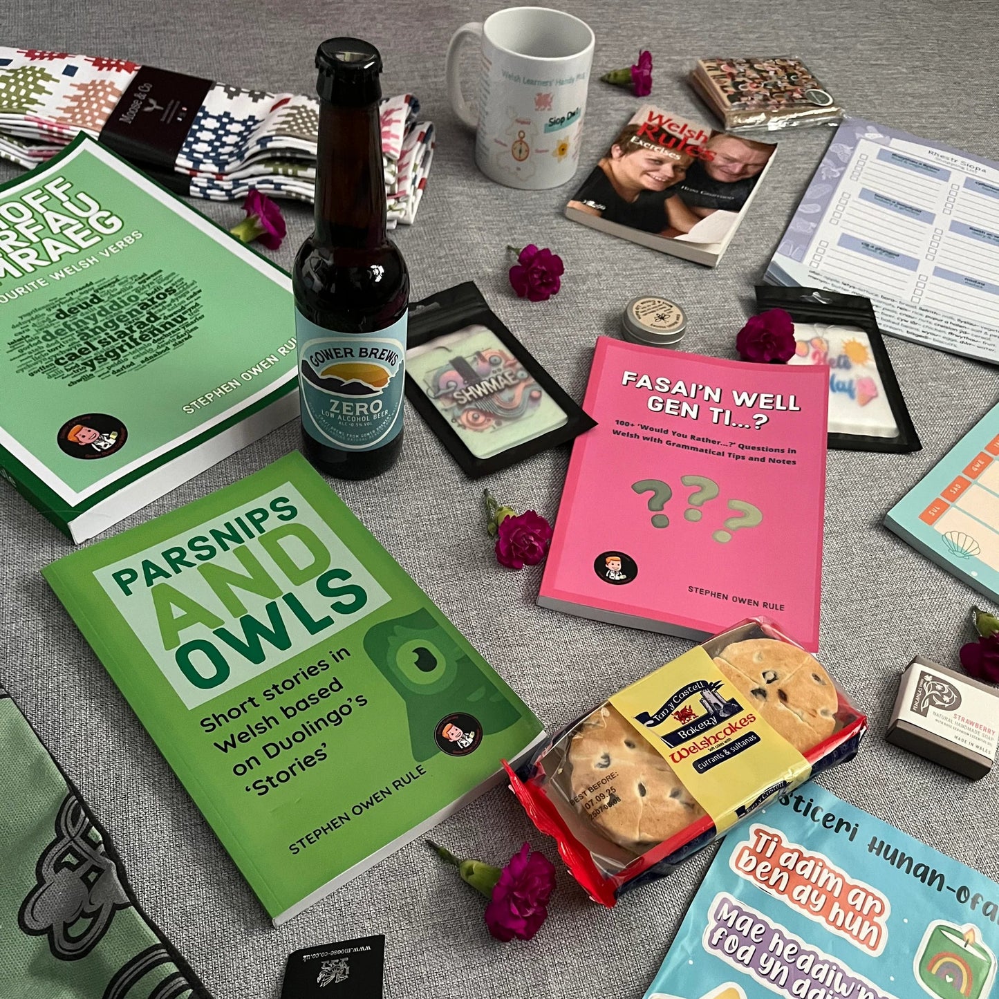 Surprise gift bundle inspired by Wales with books, beer, welsh learner notebooks, stickers.